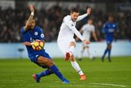 SWANSEA, WALES - FEBRUARY 12:  Gylfi Sigurdsson of Swansea City shoots past Danny Simpson of Leicester City during the Premier League match between Swansea City and Leicester City at Liberty Stadium on February 12, 2017 in Swansea, Wales.  (Photo by Stu Forster/Getty Images)
